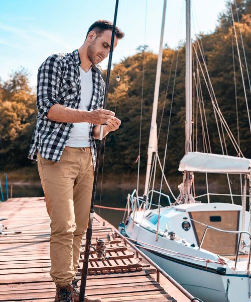 young-man-preparing-his-fishing-rod-MTH5KA6-resize.jpg